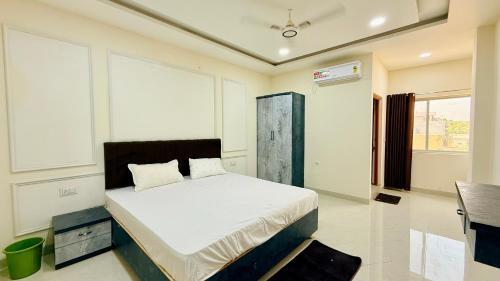 a bedroom with a bed in a room at JB Resort in Mhow