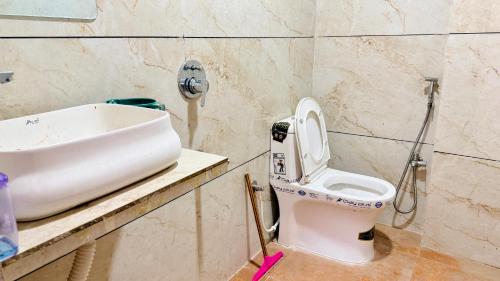a bathroom with a sink and a toilet at JB Resort in Mhow