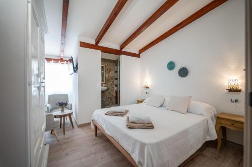 En eller flere senge i et værelse på Domo Papiros B&B