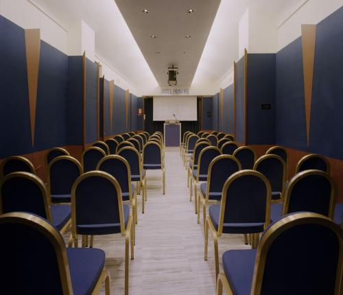 an empty lecture hall with chairs and a podium at Phi Hotel Principe in Cuneo