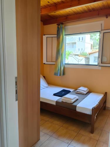 a small bedroom with a bed and a window at Emis house krioneri in Lapanayoí