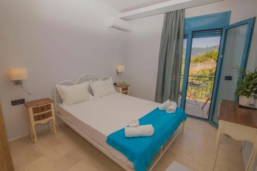 a bedroom with a bed with towels on it at Akrotiri Vasiliki in Vasiliki