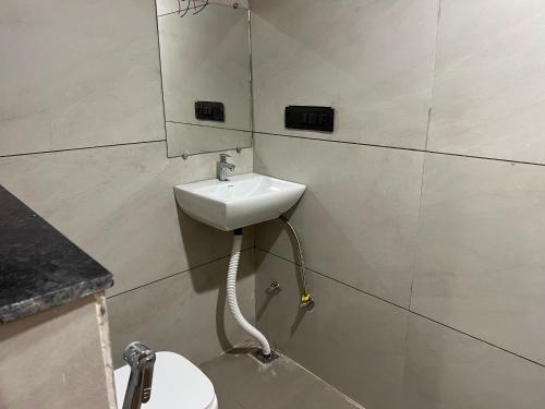 a bathroom with a sink and a toilet at hotel a sons in Chittaurgarh