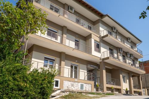 an apartment building with balconies on the side of it at Akrogiali Studios Michaniona in Nea Michaniona