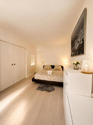 a bedroom with a bed and a dresser in a room at Champs elysees apartment 4 in Paris