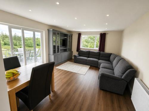 a living room with a couch and a table at Hill house Westport in Castlebar
