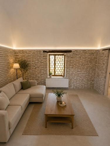 a living room with a couch and a coffee table at Turkman Madrasah XIX Century Hotel in Bukhara