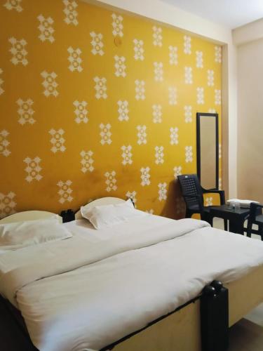 a bedroom with a bed with snowflakes on the wall at Hotel MNP in Jabalpur