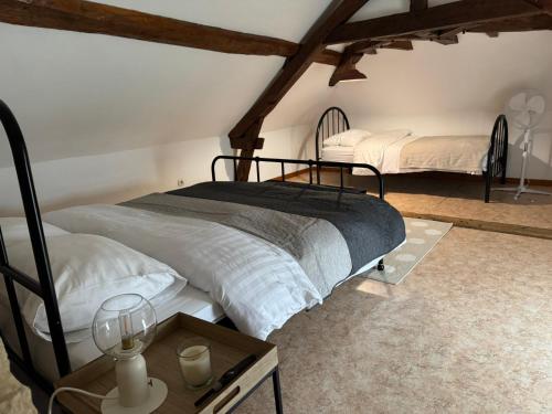a bedroom with two beds and a table with candles at Cottage B&B Chateau Saintonge breakfast included in Le Chevain