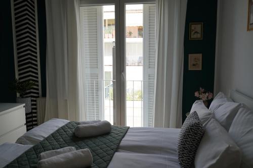 a bedroom with a bed and a large window at Titanium in Izola