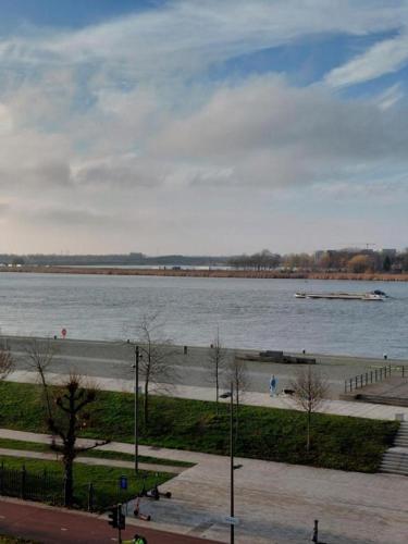 a view of a body of water with a boat at Logies De Lelie in Antwerp