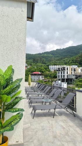 a row of chairs on the balcony of a building at PARALLEL Apartments in Gonio