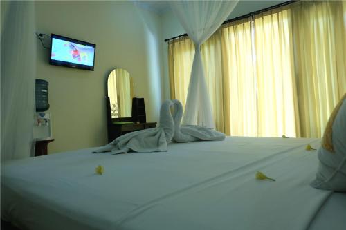 Ένα ή περισσότερα κρεβάτια σε δωμάτιο στο Eka Bali Guest House