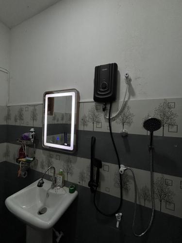 a bathroom with a sink and a mirror at Casa Bella Home in Ja-Ela
