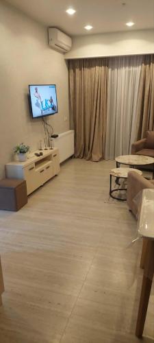 a living room with a flat screen tv on the wall at Apartament Tbilisi in Tbilisi City
