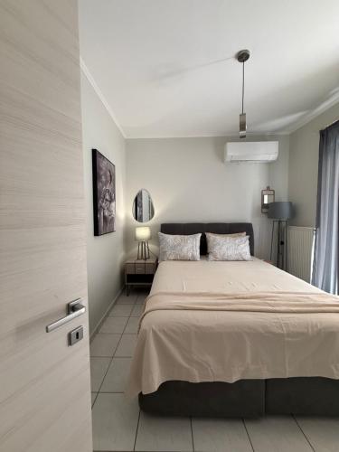 a bedroom with a large bed in a room at Blooming 31 AXD in Alexandroupoli