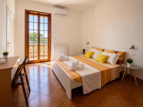 a bedroom with a large bed with towels on it at Monte Cuccu Bed & Breakfast in Cerfignano