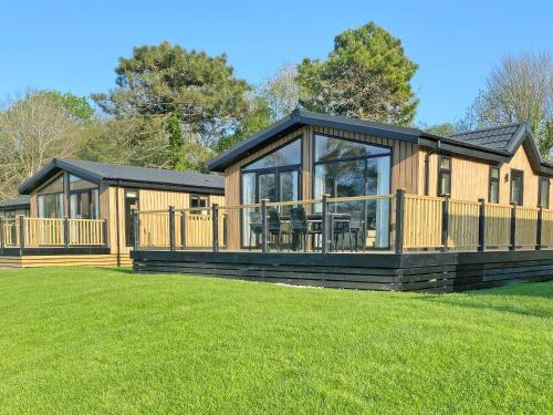 a large log cabin with a large deck at Lodge 3 - Uk51092 in Perranporth
