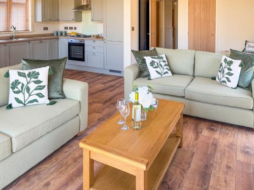 a living room with two couches and a coffee table at Lodge 3 - Uk51092 in Perranporth