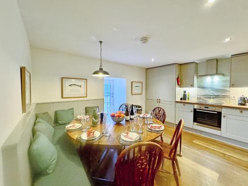 a kitchen and dining room with a table and a couch at The Fish House in Rispond