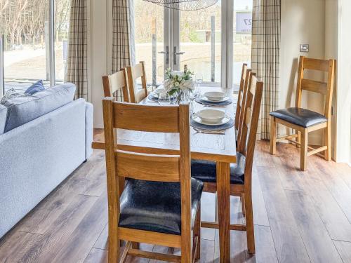 a dining table and chairs in a living room at Lodge 4 - Uk51095 in Perranporth