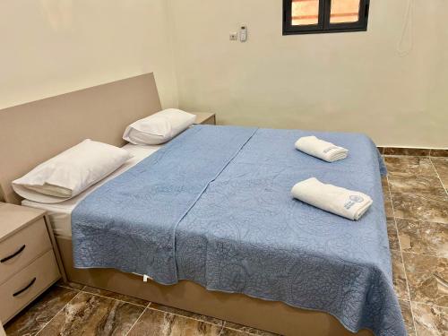 a bedroom with a bed with two towels on it at Midtown Appart Hôtel in Nouadhibou