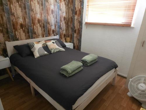 a bed with two pillows on it in a bedroom at The Lucky 7 in Hemsby