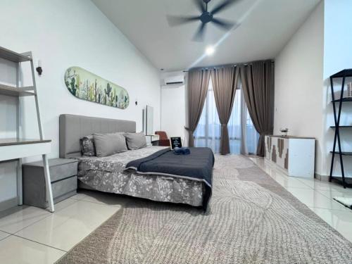 a bedroom with a bed and a ceiling fan at Zhara Homestay in Ipoh