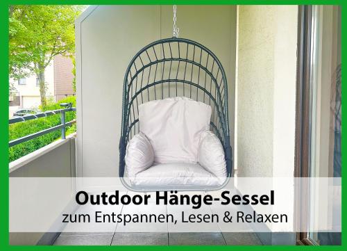a white pillow sitting in a chair on a porch at MARKs Ferienwohnung in Bad Sachsa - waldnah, hundefreundlich, ruhig! Ideal für Paare mit Hund in Bad Sachsa