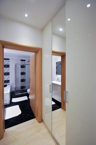 a bathroom with a walk in shower and a glass door at Villa Lina Kerkira in Gouvia
