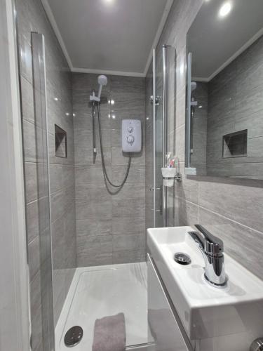 a bathroom with a sink and a shower at Pro Stay Studio in Fort William