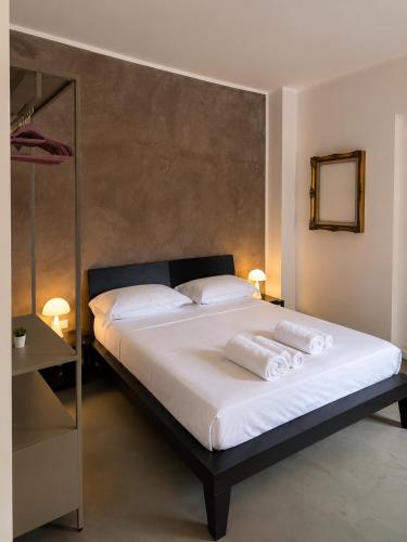 a bedroom with a bed with white sheets and pillows at Nice Sea Suite in Salerno