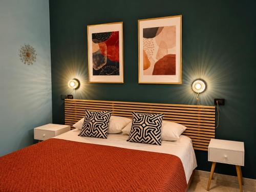 a bedroom with a red bed with two pillows at B&B La Borasca - Apartments in Casalpusterlengo