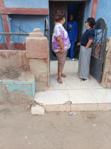two women are standing outside of a building at Abo Orabi Guest House in Aswan