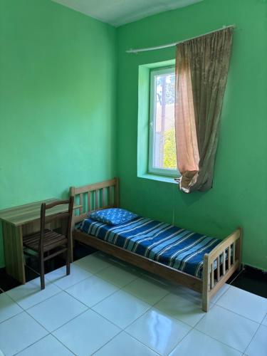 a bedroom with a bed and a window and a chair at Tolia in Ureki