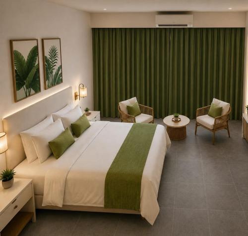 a bedroom with a large bed and green curtains at Villa España in San Narciso