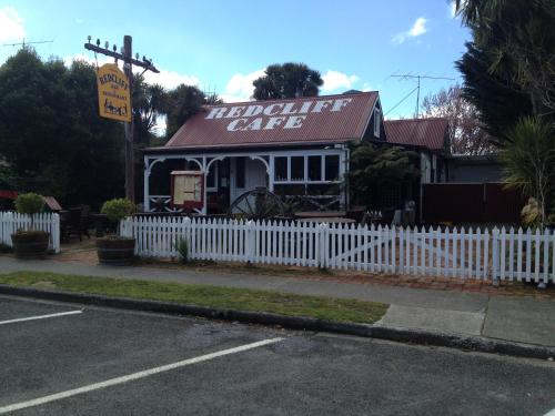 a white picket fence in front of a restaurant at Lakefront Lodge in Te Anau