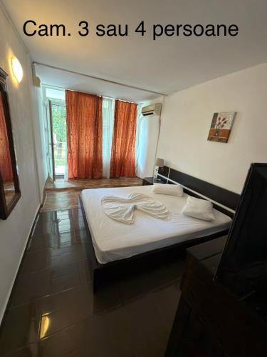 a bedroom with a bed with two white towels on it at Complex GEC-HISTRIA Mamaia in Mamaia