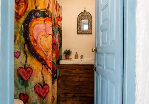 a bathroom with a painting of a woman at Caiat Lounge Refuge , Mountain Lodge near Akchour Waterfalls in Taghzoute