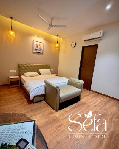 a hotel room with a bed and a table at Sefa Countryside in Sukhi Sewānia