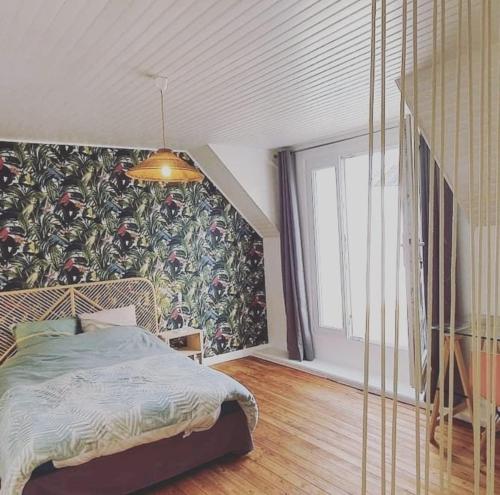 a bedroom with a bed in a room with a wall at Maison de pêcheur Quiberon in Quiberon