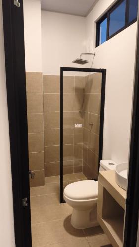 a bathroom with a shower and a toilet and a sink at Hotel Boutique 1801 in San Juan de Rioseco 