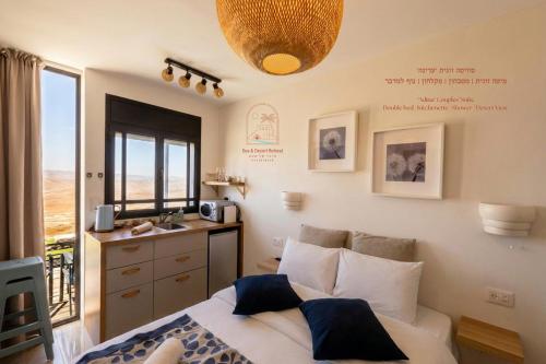 a bedroom with a bed and a sink and a window at Sun, Mountain & Adventure in Arad