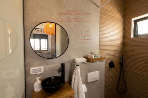 a bathroom with a mirror and a sink at Sun, Mountain & Adventure in Arad