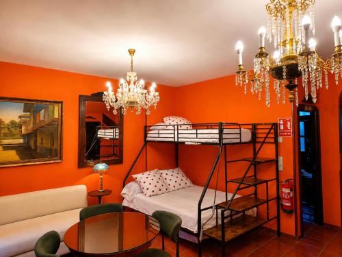 a room with two bunk beds and a couch at La Mío Quintana in Corao