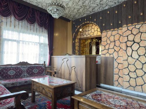a living room with a couch and a table at Otel Nisa in Nevşehir
