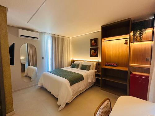 a hotel room with a bed and a mirror at Wish Residence Ap 710 in Maceió
