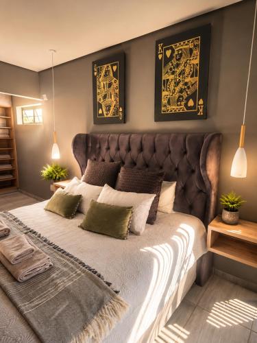 a bedroom with a large bed with green pillows at Lloyds - 3 in Ermelo