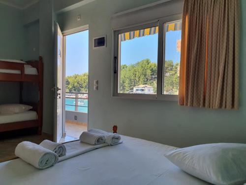 a bedroom with a large bed with towels on it at Ionian Balcony in Himare