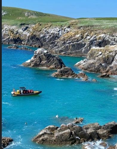 a boat in a body of water with rocks at Southeast Getaway in Limerick